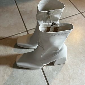Super cute white boots.